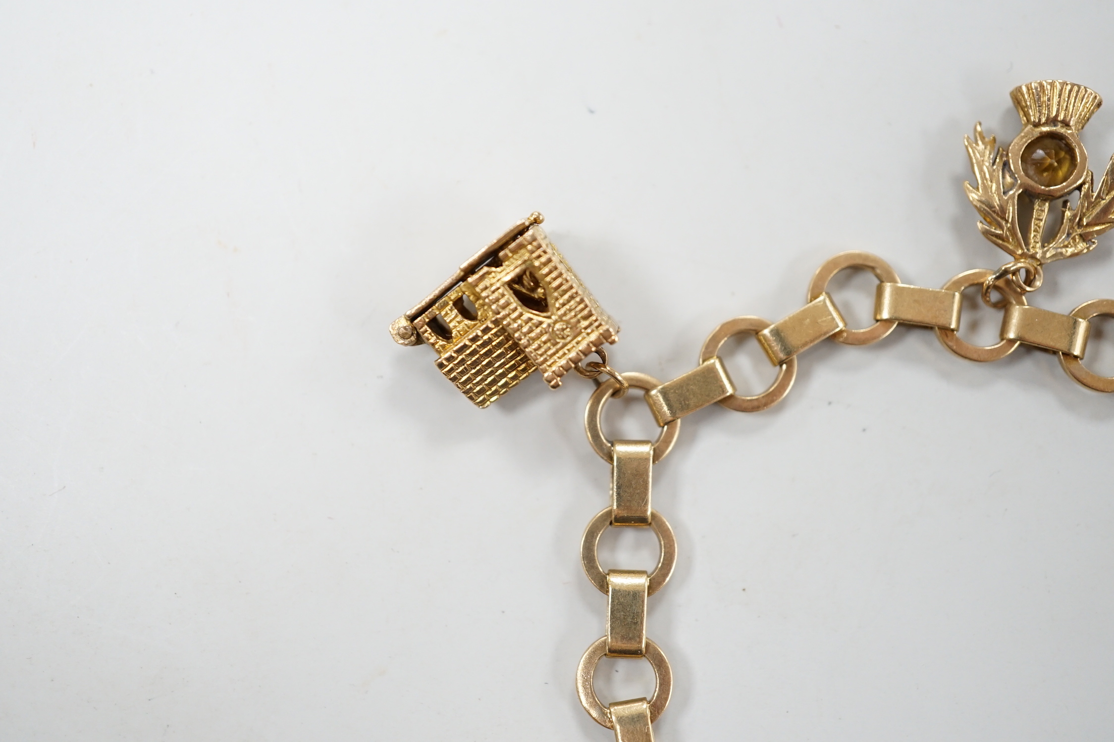 A 1950's 9ct gold charm bracelet hung with six assorted charms, gross weight 25.5 grams.